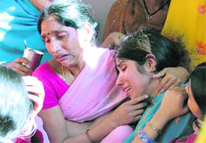 A resident consoles the victims mother, Manju Devi, in Ludhiana on Friday. 