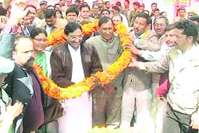 Chief Minister Ramesh Pokhriyal Nishank being greeted by BJP workers during a visit to Askot in Pithoragarh district