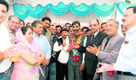 Commissioner, Industries, JC Rana offers a glass of juice to NIA press secretary Anil Sharma at Nalagarh on Saturday.