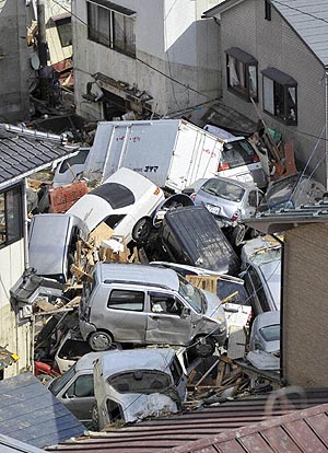 Vehicles are piled up in Kesennuma on Saturday.