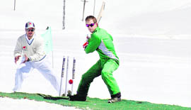 Former South African cricketer Jonty Rhodes plays a shot during a snow cricket match with the JK Tourism XI at the Gulmarg skiing resort on Saturday.