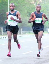 In sight of victory: Kenyans James Mutna (right) and Patrick Kamau, who came first and second, respectively, in the marathon