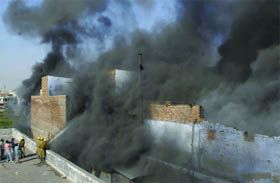 Delhi fire service men douse a fire that engulfed a plastic goods factory at Udyog Nagar on Sunday afternoon.