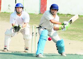 A batsman attempts an improvised shot in a match of the District Cricket League in Dehradun