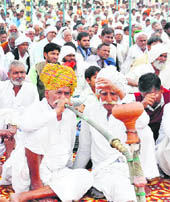 Farmers enjoy a 'hukkah' during a kisan sammelan at Ghata village in Gurgaon on Sunday.