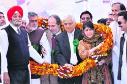 Garland greeting: PDP patron Mufti Sayeed and president Mehbooba Mufti being welcomed at the Parade Ground in Jammu on Sunday. 