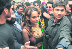 Bollywood actor Kangana Ranaut, surrounded by fans and escorted by bodyguards, soon after inaugurating a jewellery showroom in Ludhiana