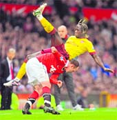 Manchester Uniteds Wayne Rooney (L) vies with Arsenals Bacary Sagna during their FA Cup quarterfinal at Old Trafford in Manchester on Saturday.