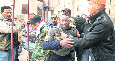 Suspected mercenaries (C) are detained by rebels in Benghazi on Sunday. 