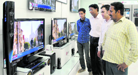 People awaiting news on Punjab Budget at a TV showroom.