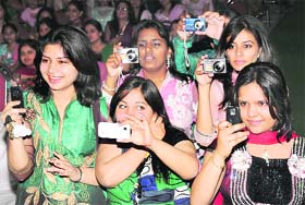 Students of KVA DAV College for Women click pictures as their classmates perform during a farewell function in Karnal