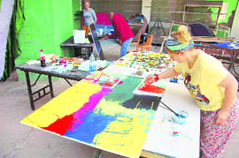 Foreign artist gives the finishing touches to her painting at an international art workshop organised byTellus Art, a Sweden-based organisation, at Dharampur in Solan district on Monday. Around 32 artists from all over the world are participating in this workshop.