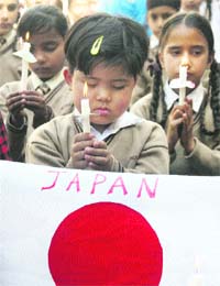 Students of Future Pack Higher Secondary School, Jammu, on Monday hold prayers for the victims of tsunami in Japan