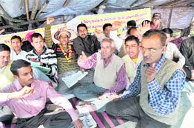 Teachers of recognised unaided schools sit on dharna near Uttarakhand Assembly in Dehradun