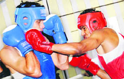  Sagar (right) punches out his opponent Pardeep in the All-India AK Mishra Memorial Boxing Championship at Skating Rink, Sector 10, Chandigarh, on Wednesday.