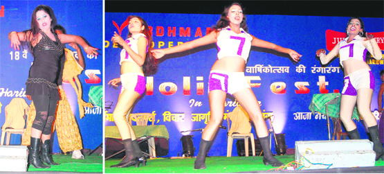 Members of a troupe dance at a Holi function in Haridwar