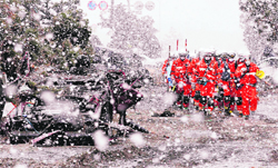 Heavy snow hinders rescue work at a devastated factory area in Sendai, northern Japan