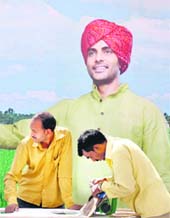A huge cut-out of a farmer errected to welcome visitors to the kisan mela beginning in PAU on Thursday. Workers can be seen in the picture making final preparations for the event. 