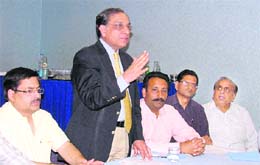 Ajit Lakra, president of the Chamber of Knitwear and Textile Association, addresses a meeting in Ludhiana protesting against the levy of 10 per cent excise duty on readymade garments on Wednesday.