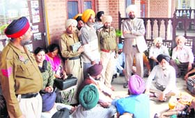 Teachers of Khalsa College, Amritsar, block a passage to the Principals office on Wednesday. Also seen in the picture is the Principal, Daljit Singh (standing first from right).
