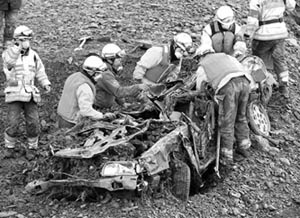 Rescue workers search for bodies after digging a car out of debris in Miyagi prefecture in northern Japan on Wednesday. 