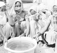 Women show dirty water at Pabhat village in Zirakpur on Thursday.