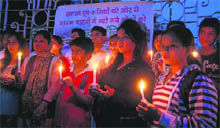 Youngsters hold candles to pay homage to the victims of the Japan earthquake and tsunami at the Gandhi Park in Dehradun on Thursday. 