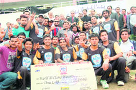 The world XI cricket team, Una, receives the trophy after winning the Jaypee Cement T-20 Cricket Mahasangram in HPCA stadium, Dharamsala, on Thursday.