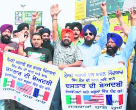Activists of the Shiromani Akali Dal (Badal) protest against ill-treatment of Amritinder Singh, coach of golfer Jeev Milkha Singh, at Amritsar
