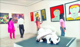 Visitors take a round at an exhibiton of paintings, sculptures and photographs at Virsa Vihar in Jalandhar on Thursday.