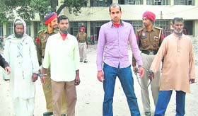Four of the accused in the Rita Bawa murder case are brought out of the court by the police in Jalandhar
