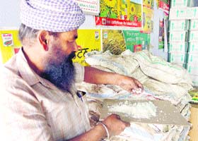 A farmer has a look at zinc in the new grain market at Rajpura