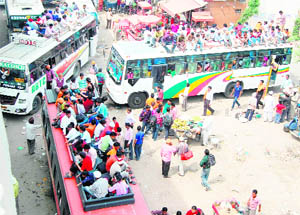 People board overloaded private buses in Amritsar.