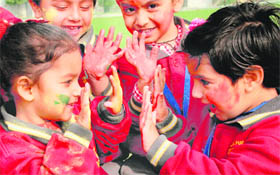 Kids can’t contain their excitement as they colour one another at Shivalik Public School, Phase VI, Mohali, on Friday