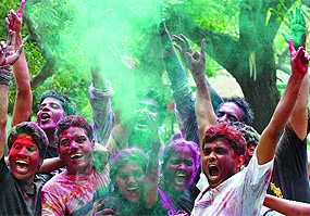 Students of Delhi University celebrate Holi at Faculty of Arts on Friday.
