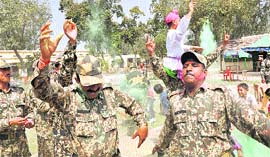 BSF personnel celebrate Holi at the octroi post in the Suchetgarh area on the international border in Jammu on Friday.