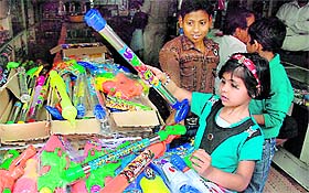 A girl makes purchases ahead of the Holi festival in Dhobi Bazar, Bathinda, on Friday.