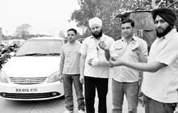 Charanjit Singh, Harjinder and Harpreet show car parking slips. The three were overcharged at the  parking lot of the PGI, Sector 12, Chandigarh