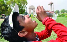 A child drinks water during the Walk for Water in New Delhi