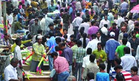 People throng Sadar Bazar on the eve of holi festival in Old Delhi