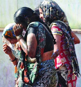 Women celebrate holi at a temple in New Delhi