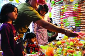 People throng Sadar Bazar on the eve of holi festival in Old Delhi