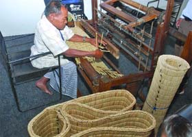 OVERCOMING DISABILITY: Mangi Singh from Manipur, a paraplegic, weaves Kauna mats with his innovative machine during the Innovation Exhibition at Mughal Gardens in Rashtrapati Bhavan