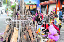 Women pray before lighting the Holika bonfire in Dehradun