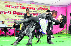 A couple dances at a Holi Milan function organised by the Bharat Vikas Parishad in Dehradun