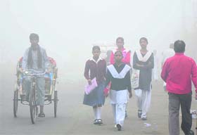 Fogged in march! Students on their way to school during thick fog in Sector 12, Karnal