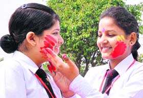 Students apply colours on each other in Jalandhar