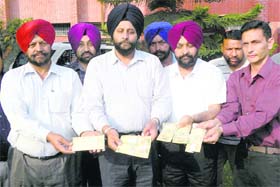 Police officials show fake currency notes seized from a smuggler in Amritsar