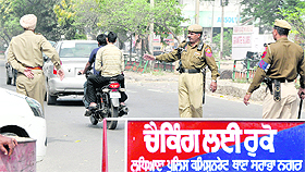 Cops guide vehicles during Holi in Ludhiana on Saturday.