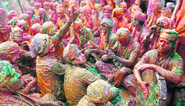 According to tradition, men from Lord Krishna's Nandgaon visit Barsana to play Holi